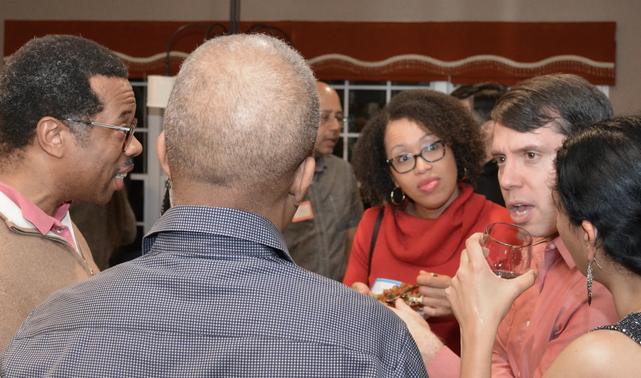group of people enjoying drinks at social gathering